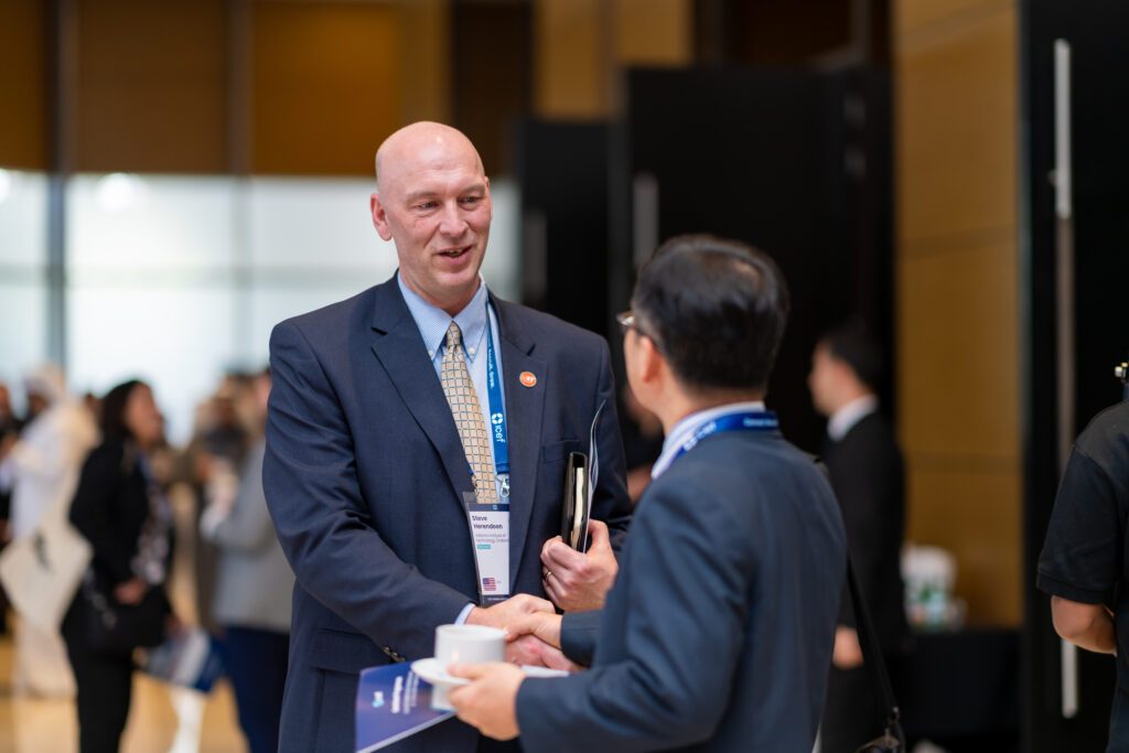Two delegates in conversation during a networking break at a previous ICEF scholarship summit