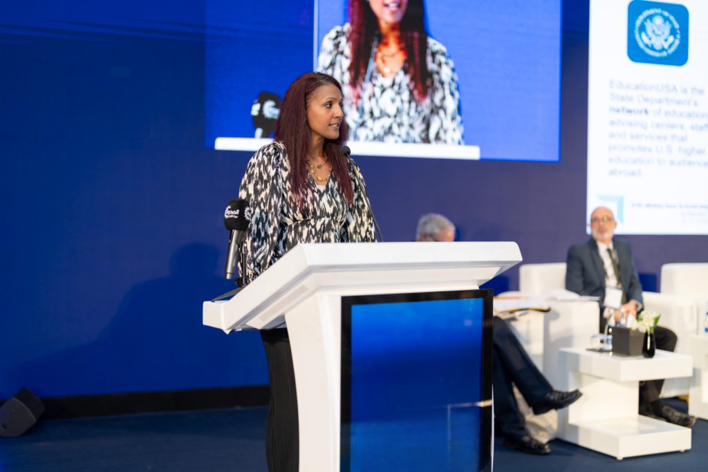 A speaker addresses delegates from the podium at a previous ICEF scholarship summit
